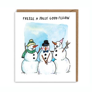 May include: A greeting card with a watercolor background featuring three snowmen. The text "Freeze a Jolly Good Fellow" is written at the top of the card.