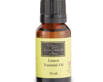 May include: A small amber glass bottle with a black cap, labeled "Lemon Essential Oil" by Karma Naturals. The bottle contains 15 ml of oil.