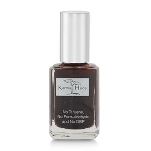 May include: A clear glass bottle of Karma Hues nail polish in a dark brown color with a silver cap. The bottle has a label with the brand name and the text "No Toluene, No Formaldehyde and No DBP."