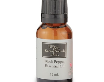 May include: A 15 ml amber glass bottle of Karma Naturals Black Pepper Essential Oil with a black ribbed screw cap. The label features a white plant icon, the brand name, product name, and a small pink heart icon with text below.