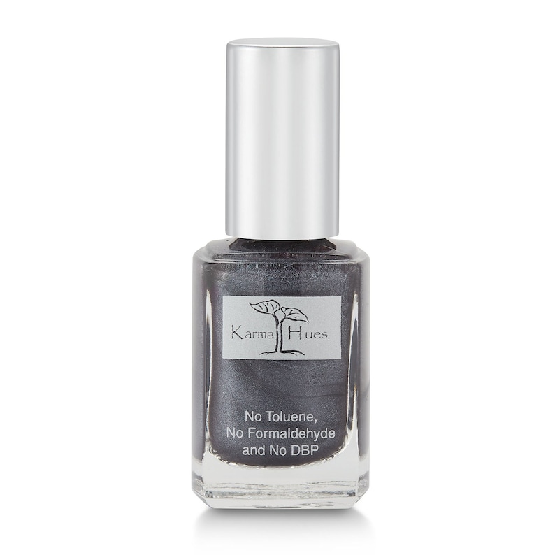 May include: A bottle of Karma Hues nail polish in a dark gray color with a silver cap. The bottle has a label that says "Karma Hues" and "No Toluene, No Formaldehyde and No DBP".