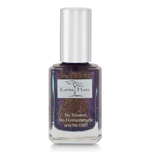 May include: A bottle of Karma Hues nail polish in a deep purple color with gold glitter. The bottle is labeled "No Toluene, No Formaldehyde and No DBP".