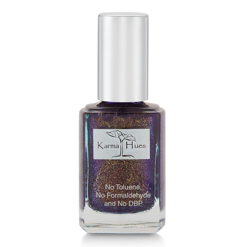 May include: A bottle of Karma Hues nail polish in a deep purple color with gold glitter. The bottle is labeled "No Toluene, No Formaldehyde and No DBP".