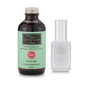 May include: Two bottles of nail polish remover. The larger bottle is brown glass with a green label that reads "Karma Naturals Nail Polish Remover with Soybean Oil & Tea Tree Oil." The smaller bottle is clear glass with a silver cap and a white label that reads "Karma Hues 0.5 fl oz (15 ml) Nail Polish Remover No Formaldehyde and No DBP."