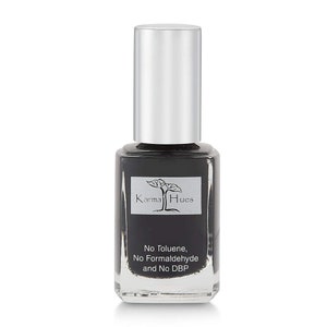 May include: A black nail polish bottle with a silver cap. The bottle has a label that says "Karma Hues" and "No Toluene, No Formaldehyde and No DBP".