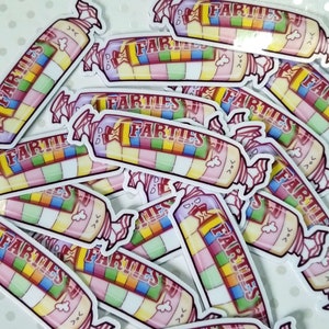 May include: A close-up of multiple colorful candy stickers with the text "FARTLES" on each sticker. The stickers are shaped like a candy bar with a rainbow pattern and a pink and white wrapper.