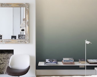 May include: A white bedroom with a white bed, a white chair, and a white shelf with books. The wall behind the shelf is painted a gradient of light beige to dark green.