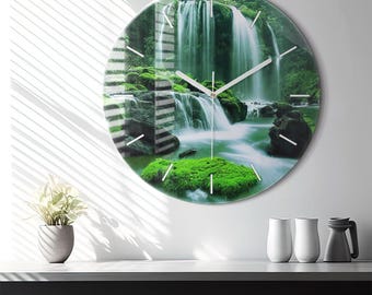 May include: A round wall clock featuring a high-resolution photographic print of a lush waterfall cascading over moss-covered rocks. The clock face has thin, silver-colored hour and minute hands and simple white tick marks for the hour indicators.