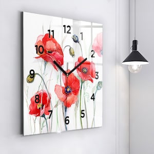May include: Square glass clock with black hands and black numbers on a white background with a watercolor design of red poppies.
