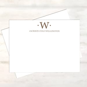 May include: White stationery card with a brown initial "W" and the text "JACKSON COLE WELLINGTON" printed in brown.