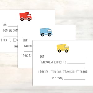 May include: Three blank thank you cards with a red, blue, and yellow truck illustration on each card. The cards have the text "Dear", "Thank you so much for the", "I think it's", "so cool", "awesome", "the best", and "Your friend" printed on them.
