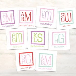 May include: A collection of personalized cards with initial monograms. Each card features a unique combination of letters within a square frame, with names printed below. The color palette includes pink, green, purple, and red.