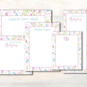 May include: A set of four rectangular paper notepads featuring a border pattern of colorful Mahjong tiles, including birds, flowers, and fans. The pads display text such as CRACK DOT BAM, TO DO AFTER Mahjong, Mollie Claire, and the initials PAG in pink and blue.