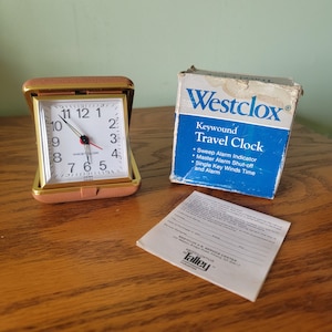 Vintage Westclox keywound travel luminous alarm clock with tan plastic case and original box