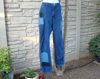 May include: Blue denim jeans with multiple patches of different shades of blue denim. The jeans have a straight leg and a relaxed fit.