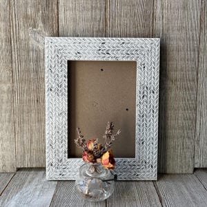 May include: A rustic wooden sign with the text "Welcome to our home" in white lettering. The sign features a distressed finish and a simple, inviting design, perfect for front door decor.