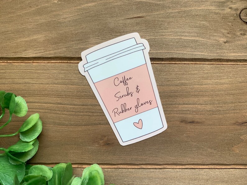 May include: A sticker of a coffee cup with the text "Coffee, Scrubs & Rubber Gloves" and a small pink heart.