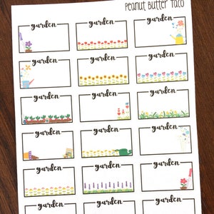 May include: A sheet of 18 blank garden labels with colourful flower and plant illustrations. Each label has the word "garden" written on it.