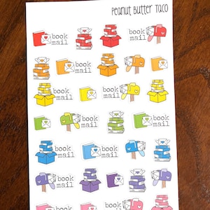May include: A sheet of stickers featuring illustrations of mailboxes with stacks of books inside. The text "book mail" is repeated on each sticker. The text "Peanut Butter Taco" is at the top of the sheet.