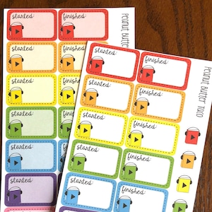 May include: Two sheets of colorful stickers with a headphone and play button design. The stickers are labeled "started" and "finished" and are meant for tracking progress on audio books. The text "Peanut Butter Taco" is printed on one sheet and "Peanut Butter" is printed on the other sheet.