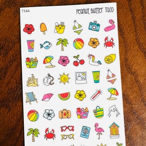 May include: A sheet of summer-themed stickers with various colorful illustrations. Designs include a camera, flamingo, beach ball, sunglasses, passport, and other vacation-related icons. The text "Peanut Butter Taco" is visible.