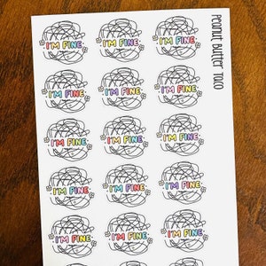 May include: A sheet of stickers featuring the phrase "I'M FINE" in colourful lettering, set against a scribbled design with small flower accents. The stickers are on a white background, with the words "Peanut Butter Taco" printed vertically on the right.