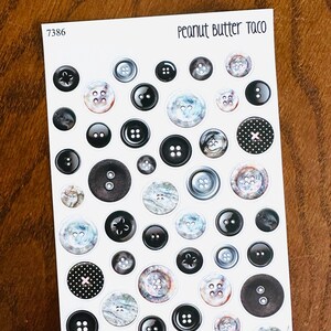 May include: Sheet of stickers featuring various button designs. The stickers include black, white, and marbled buttons, some with decorative details. The text "Peanut Butter Taco" is at the top right.