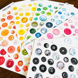 May include: Sheets of colorful button stickers in various sizes and designs. The stickers feature a range of colors, including red, orange, yellow, green, blue, pink, and black. Some buttons have striped or patterned details. The text "Peanut Butter" is visible.