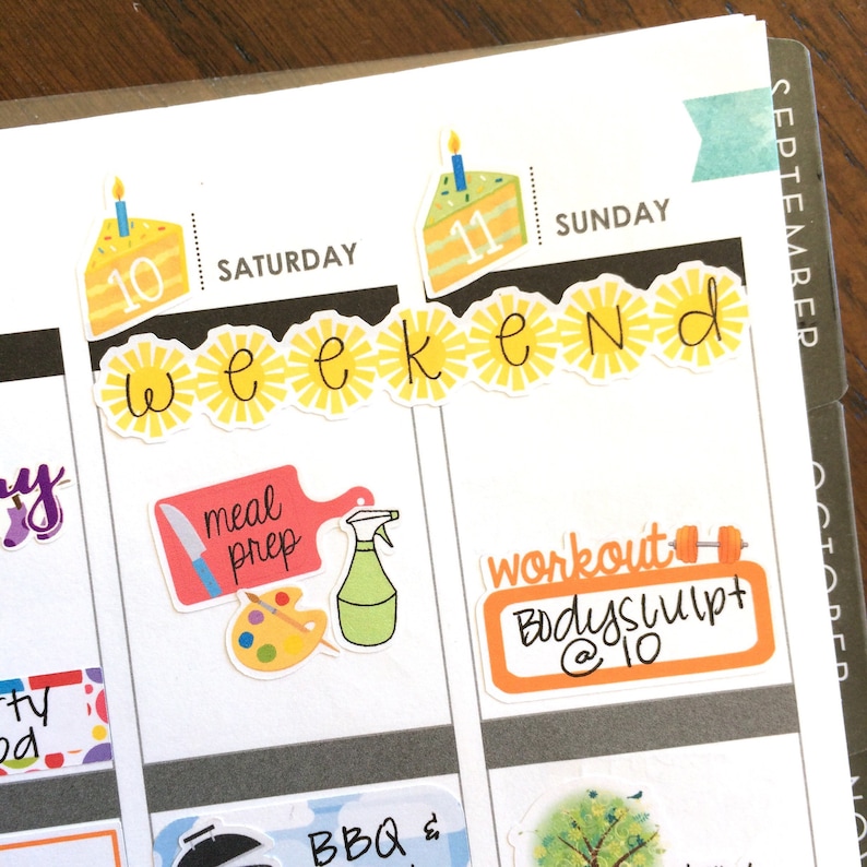 May include: A weekly planner with stickers for meal prep, workout, and birthdays. The stickers are colourful and feature illustrations of a knife, a spray bottle, a paint palette, a dumbbell, and a cake.