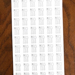 May include: A sheet of white sticker paper with 48 black and white outline stickers of a fork, knife, and spoon. The text "Peanut Butter Taco" is printed at the top of the sheet.