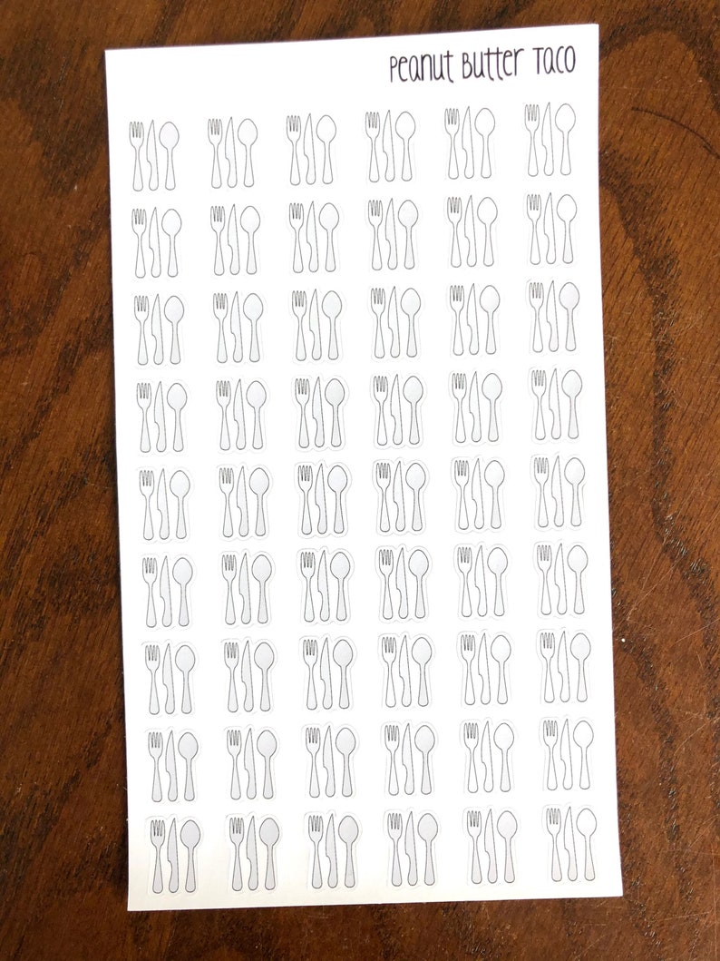 May include: A sheet of white sticker paper with 48 black and white outline stickers of a fork, knife, and spoon. The text "Peanut Butter Taco" is printed at the top of the sheet.