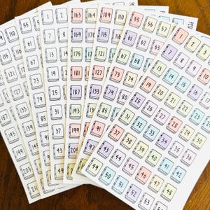 May include: Multiple sheets of rectangular stickers featuring small, hand-drawn book icons in pastel shades of pink, yellow, blue, and purple. Each book icon contains a unique black printed number, organized in sequential columns.
