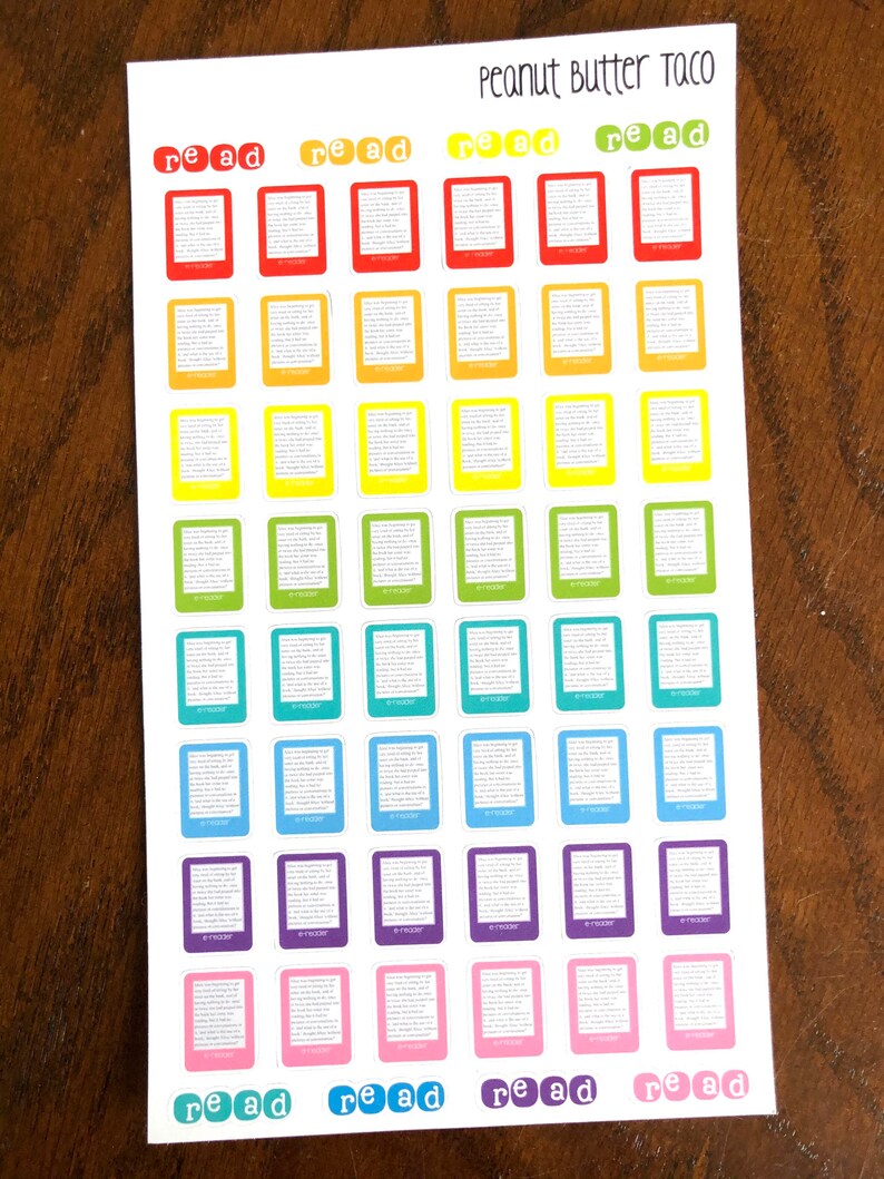 May include: A sheet of colorful book-shaped stickers with the text "read" in white letters on a red background. The stickers are arranged in rows and columns, with each row featuring a different color. The colors are red, orange, yellow, green, blue, purple, and pink. The sheet is labeled "Peanut Butter Taco" at the top.