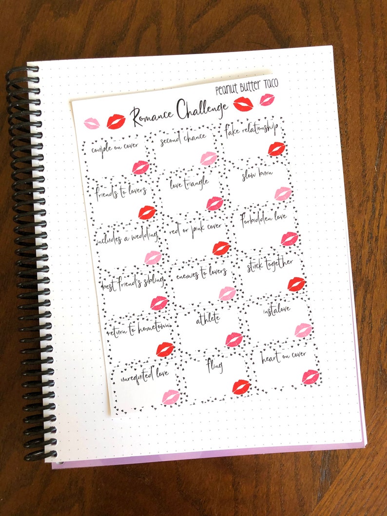 May include: A white sheet of paper with black hearts and red lips printed on it. The paper is divided into squares with text in each square. The text includes "Romance Challenge", "couple on cover", "second chance", "fake relationship", "friends to lovers", "love triangle", "slow burn", "includes a wedding", "red or pink cover", "forbidden love", "best friend's sibling", "enemies to lovers", "stick together", "return to hometown", "athlete", "instalove", "unrequited love", "fling", and "heart on cover".