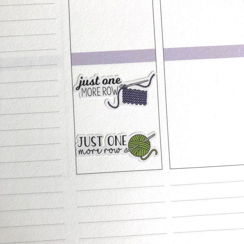 May include: Two stickers with the text "Just one more row" and illustrations of knitting needles and yarn. One sticker has a purple yarn ball and the other has a green yarn ball.