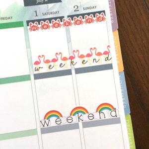 May include: A set of colourful planner stickers with the word "weekend" written in black script. The stickers feature a rainbow, flamingos, and crabs.