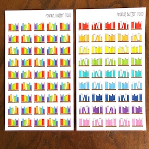 May include: Two sheets of colorful book-shaped stickers with the text "Peanut Butter Taco" at the top of each sheet. The stickers are arranged in rows and columns, and each sticker features a different color scheme.