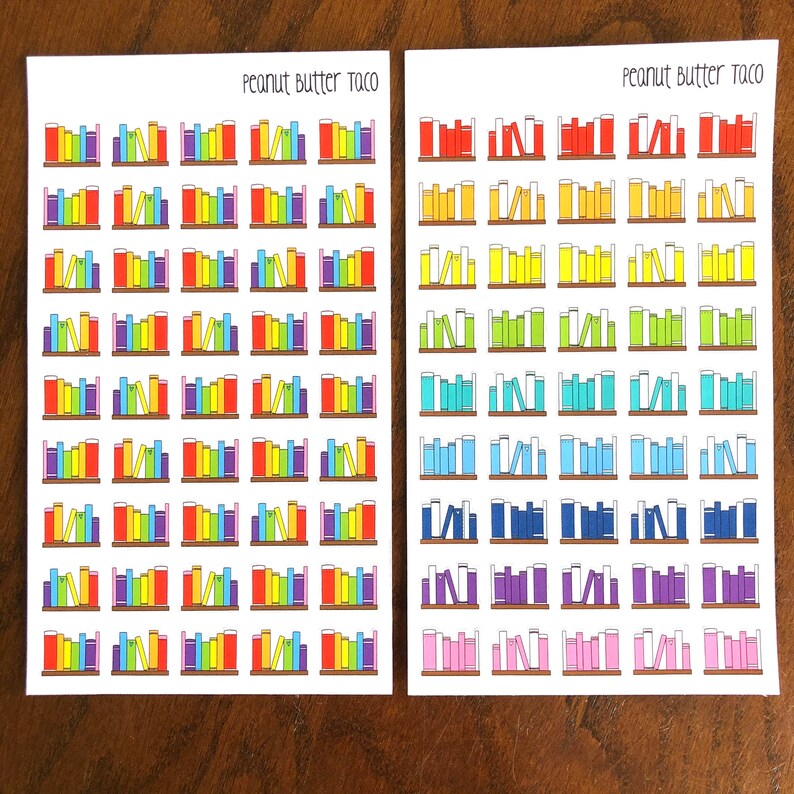 May include: Two sheets of colorful book-shaped stickers with the text "Peanut Butter Taco" at the top of each sheet. The stickers are arranged in rows and columns, and each sticker features a different color scheme.