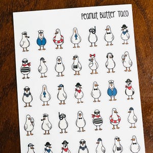 May include: A sheet of stickers featuring cartoon ducks in various outfits and accessories. The ducks are white with yellow feet and beaks. Some ducks wear hats, sunglasses, bow ties, and life preservers. The text "Peanut Butter Taco" is at the top.