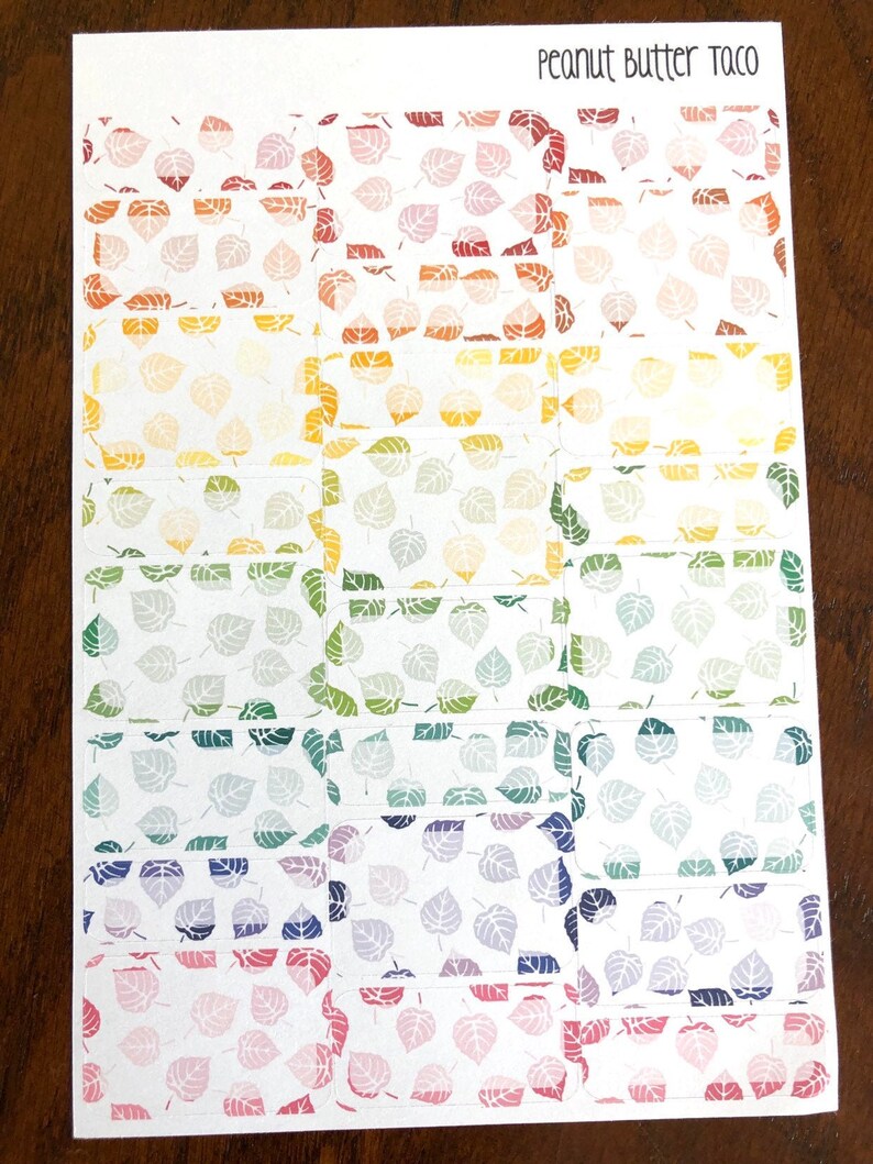 May include: A sheet of colorful leaf patterned stickers with the text "Peanut Butter Taco" at the top. The stickers are arranged in rows of 4, with each row featuring a different color gradient.