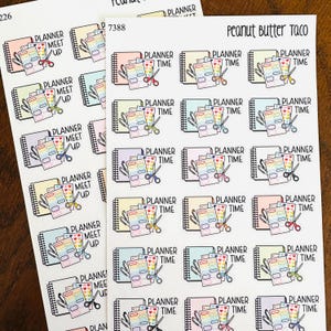 May include: Sheets of planner stickers with colorful notebooks, scissors, and text that reads "Planner Meet Up" and "Planner Time." The stickers are in various pastel colors, perfect for organizing and decorating planners.