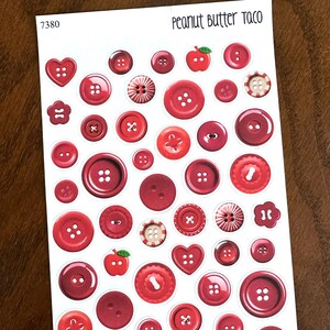 May include: Sheet of red button stickers in various sizes and shapes, including hearts, flowers, and apples. The text "Peanut Butter Taco" is at the top. The sticker sheet also has the number "7380" in the upper left corner.