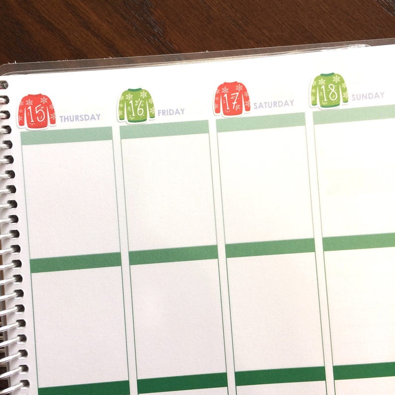 May include: A weekly planner with green and white squares and red and green Christmas sweater stickers with numbers 15, 16, 17, and 18. The days of the week are labeled Thursday, Friday, Saturday, and Sunday.