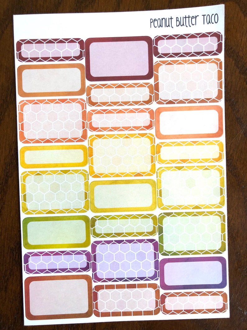 May include: A sheet of 20 rectangular stickers with a honeycomb pattern in various colors, including purple, orange, yellow, and brown. The stickers are blank and can be used for labeling or decorating. The text "Peanut Butter Taco" is printed at the top of the sheet.