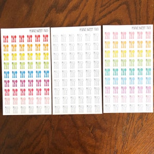 May include: Three sheets of stickers with a rainbow gradient of colors. Each sheet has a design of a fork, knife, and spoon. The text "Peanut Butter Taco" is printed at the top of each sheet.