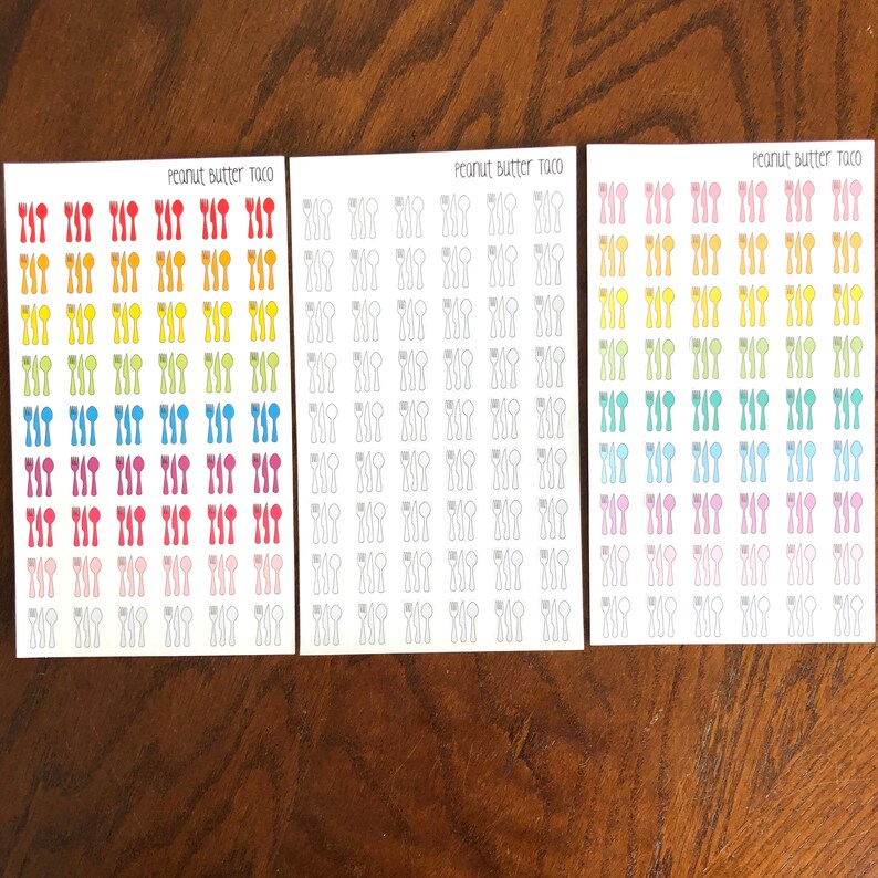 May include: Three sheets of stickers with a rainbow gradient of colors. Each sheet has a design of a fork, knife, and spoon. The text "Peanut Butter Taco" is printed at the top of each sheet.