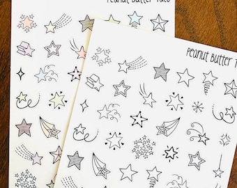 May include: Two sheets of sticker paper with black and white illustrations of stars and shooting stars. The top sheet has the text "Peanut Butter Taco" and the bottom sheet has the text "Peanut Butter Taco".