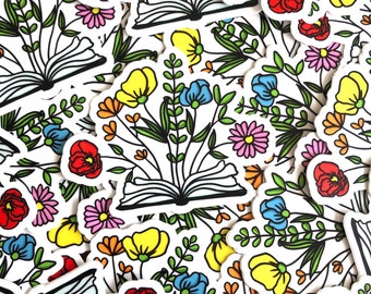 May include: A collection of colourful stickers featuring illustrations of flowers, books, and butterflies. The stickers are printed on white paper and have a glossy finish.