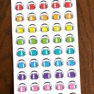 May include: A sheet of 40 colorful stickers featuring a stack of books with headphones on top. The stickers are arranged in 8 rows of 5 stickers each. The colors of the stickers are red, orange, yellow, green, blue, purple, pink, and white.
