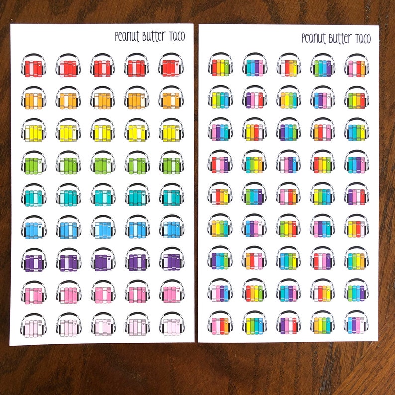 May include: Two sheets of stickers with a rainbow color scheme. Each sticker features a stack of books with headphones on top. The text "Peanut Butter Taco" is printed at the top of each sheet.